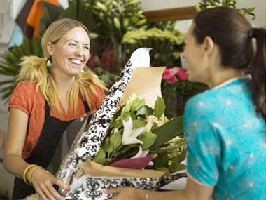 Florist giving flowers to customer